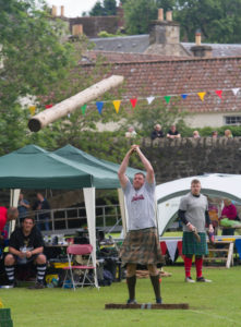 Man in a kilt, tossing the caber