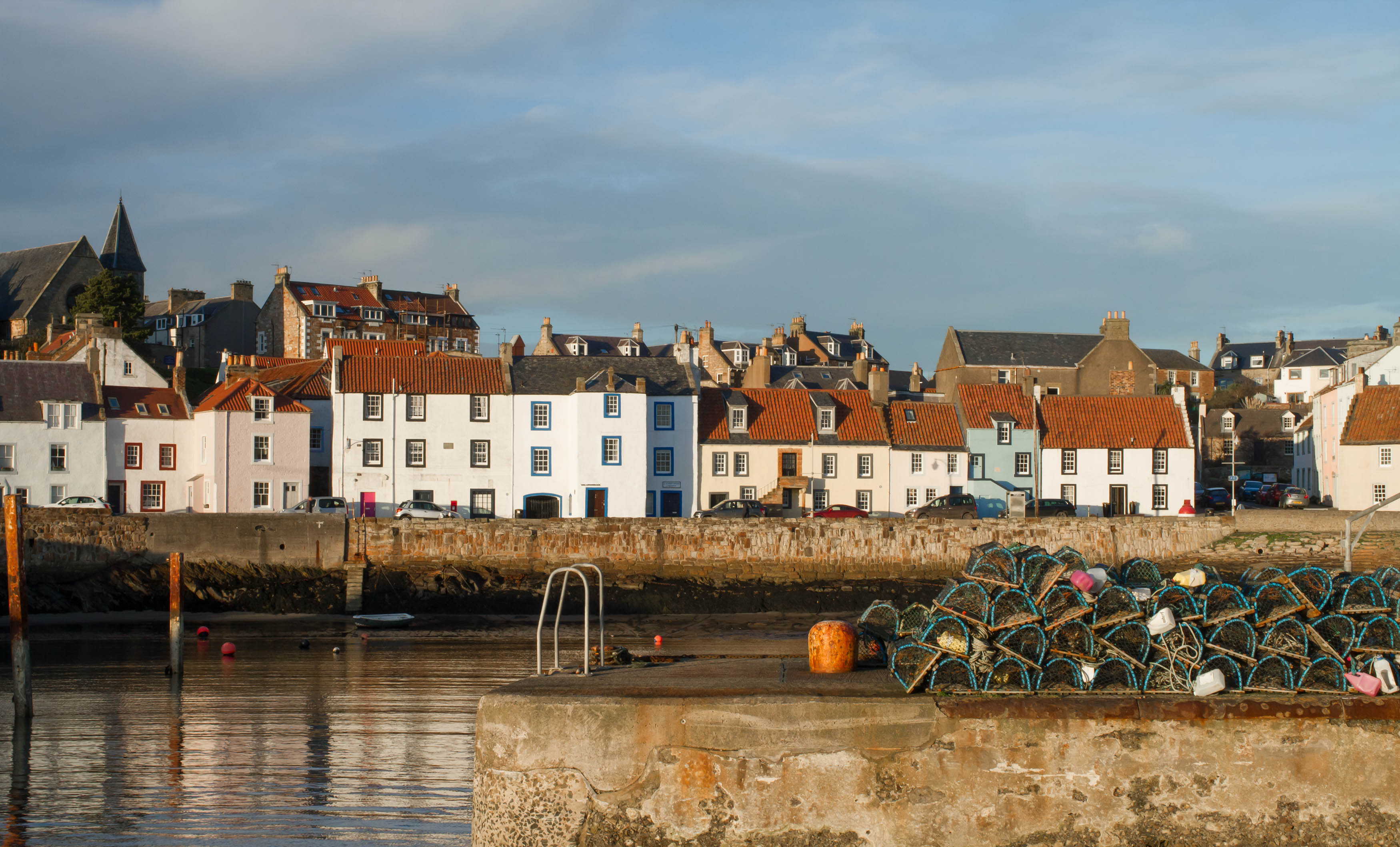 Catchpenny Safari Lodges, Elie, East Neuk, Fife, Scotland. Photo of the harbour. White houses with orange roofs. 