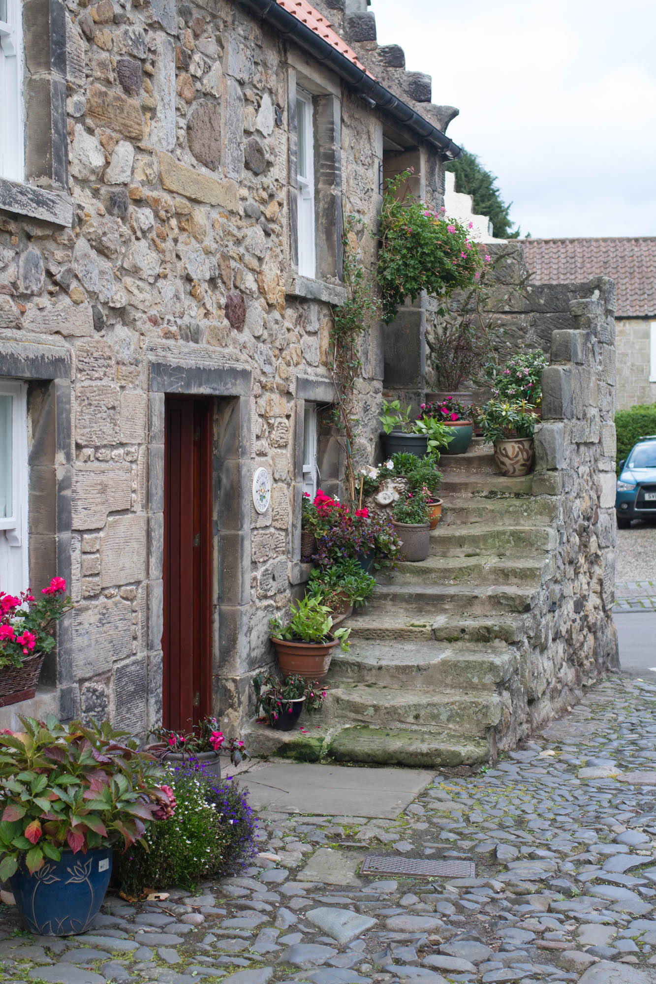 Cute wee house in Falkland, Fife. Flower pots on the steps 