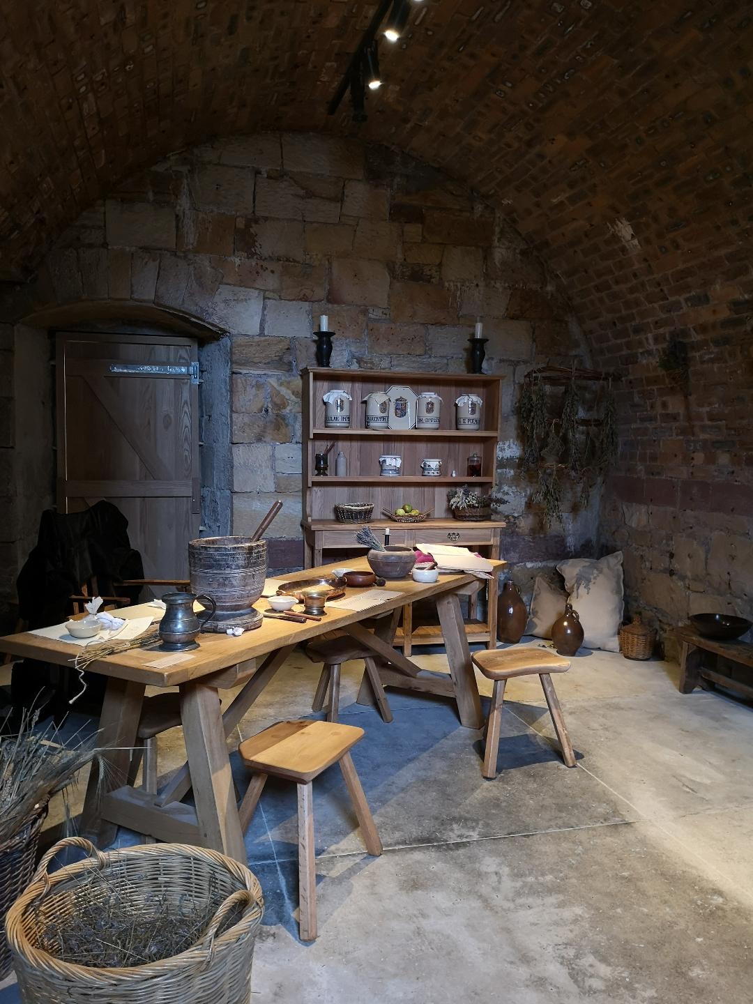 Apothecary in the cellars of Falkland Palace. Wooden bench with utensils on 