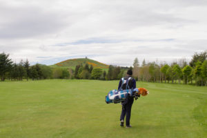 Insch Golf Course. Golfer walking with clubs