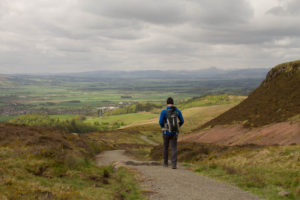 Find your Scotland. Person walking in the hills in Scotland