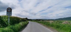 Country road with 40mph sign at the side