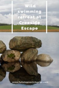Pin for later. An image of rocks in the water with their reflection showing