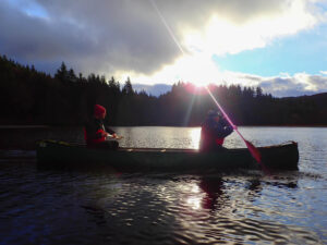 Photo of a man and woman in a canoe.